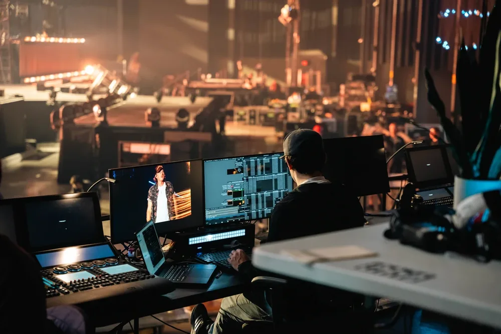 Jonathan Laosy programming a Disguise media-server timeline at front of house during rehearsal